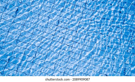 Water background texture. Blue wave pool surface. Summer sea abstract pattern