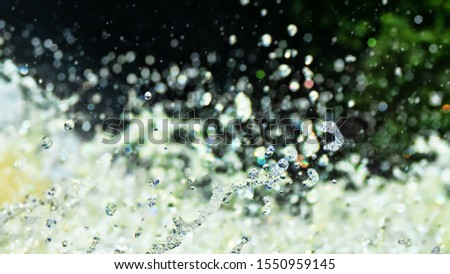 Water backgrounds with foam spray fast flow. The water in mad flows with droplets and whirlpools of waterfalls.