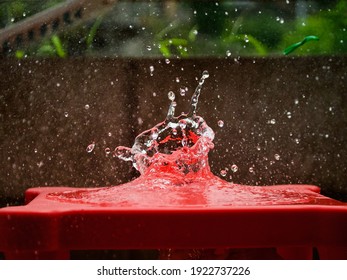 Water Ballon Popping On Red Table