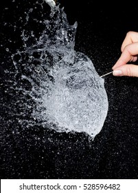 Water Balloon Exploding As A Pin Pricks It