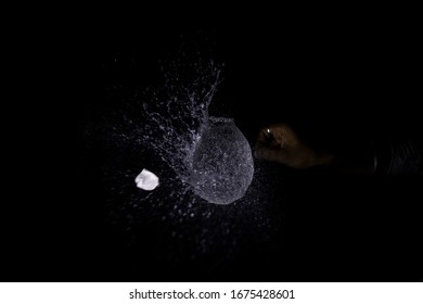 Water Balloon Splash With Pin In A Black Background