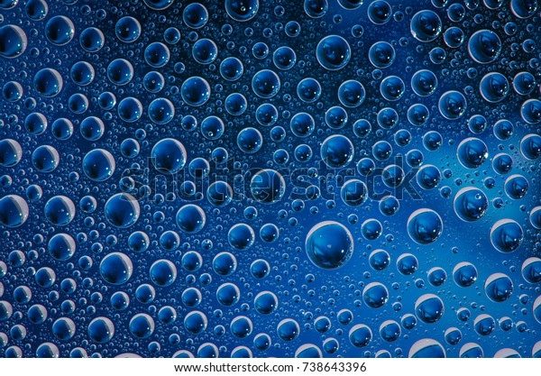 Water beads on
glass with coloured
background