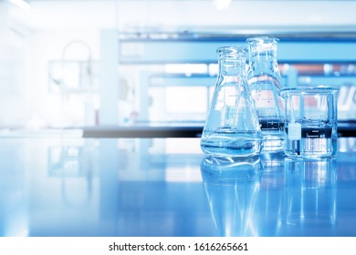 Water In Beaker And Flask Glass In Chemistry Blue Science Laboratory Background