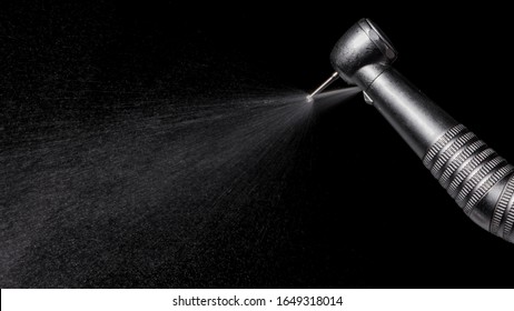 Water being sprayed out from a dental highspeed handpiece