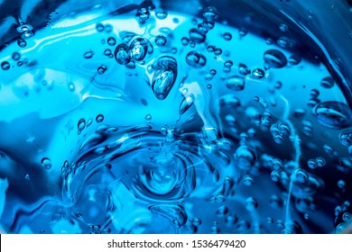 Water blue gel balls. Polymer gel. Silica gel. Balls of blue hydrogel. Crystal liquid ball with reflection. Texture background. Close up macro. Soapsuds background with air bubbles.