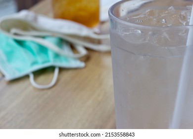 Water With Blur Mask On Table Under Concept Of Business In Post Covid