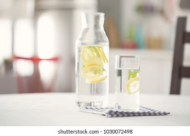 Water Bottel And Glass Of Water With Lemon In Kitchen