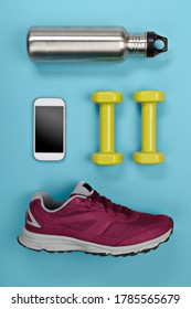 Water Bottle With Weights, Mobile Phone And Running Shoe In A Top Down View.