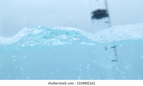 Water and bubbles with a syringe dip in blue water - Powered by Shutterstock