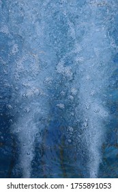 Water and bubbles, that were ejected from the Jacuzzi, on blue background