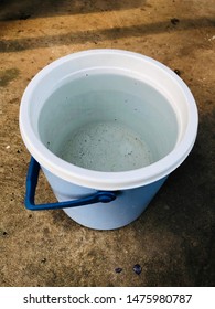 Water In Bucket On Floor Background.Rain Water Tank On Concrete Backdrop.Small Blue Tank For Secondary Rain Water For Use In The Future.Important Rainwater.Rainy Season.