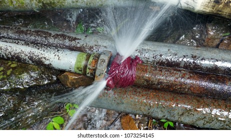 Water burst from a jointer of 2 inch rustic steel pipe