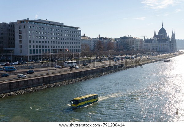 Water bus or amphibian transport at the Main\
Building of Budapest city\
background