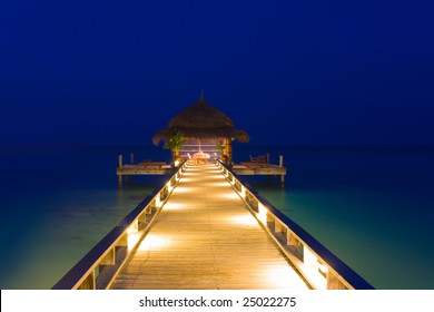 Water cafe at night, lights, ocean and sky