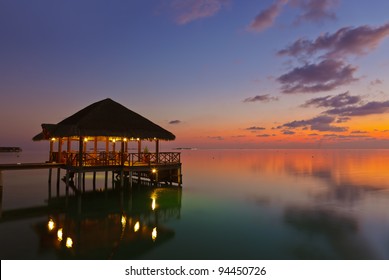 Water cafe at sunset - Maldives vacation background