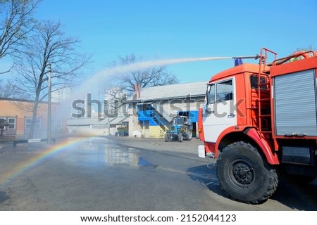 Water cannon of a firetruck shooting a high-velocity stream of water during training