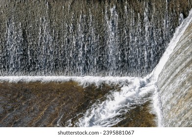 Water cascading on the walls of a dam - Shutterstock ID 2395881067