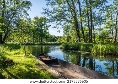 Water channel in the Spreewald Biosphere Reserve in Brandenburg, Germany, with one of the typical wooden boats.