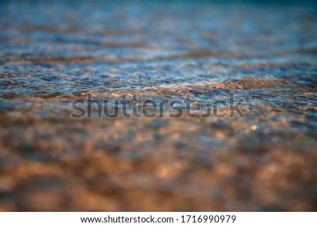 water close up texture of wavelets on sand
