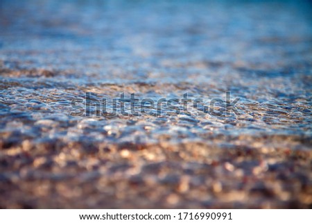 water close up texture of wavelets on sand