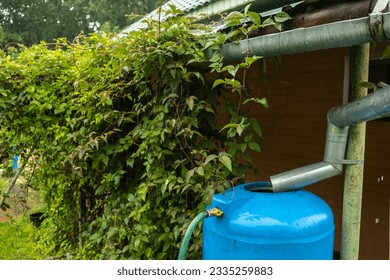 water collection tank under a roof with a drain. Rain water harvesting architecture. Top view - Shutterstock ID 2335259883