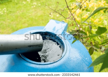 water collection tank under a roof with a drain. Rain water harvesting architecture. Top view. Blur and selective focus