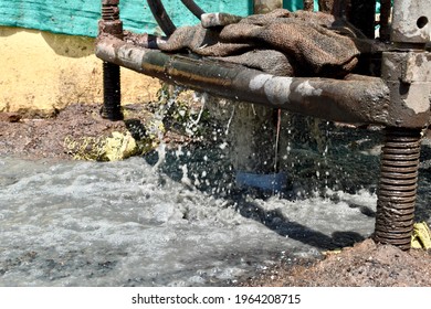 Water Coming From Ground Water Well Drilling And Base Of Drilling Equipment.