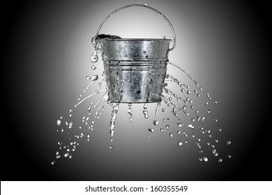 water is coming out of a bucket with holes