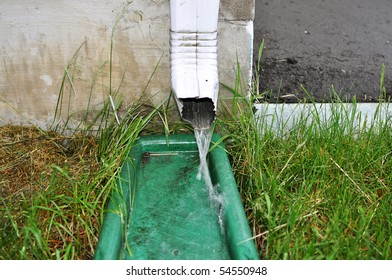 Water Coming Out Of Downspout In Rain