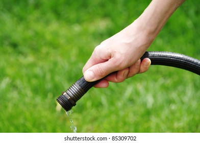 Water Coming Out Of Hose In Hand