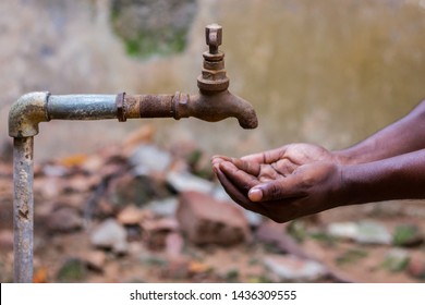 Water Crisis Is A Serious Threat To India And Worldwide,a Man Holding His Hand Under The Tap For Water