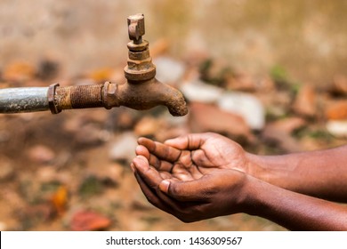 Water Crisis Is A Serious Threat To India And Worldwide,a Man Holding His Hand Under The Tap For Water