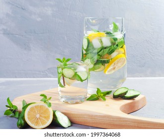 Water with cucumber, lime and mint on a gray rustic background. In a glass decanter - Powered by Shutterstock