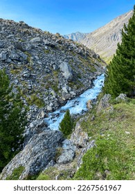 The water of the current alpine river among the stones flows in the Altai mountains in Siberia. Vertical frame. - Shutterstock ID 2267561967