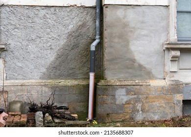 Water Damage Of A House. Wet Exterior Wall Caused By A Leakage In A Tube Of The Roof Gutter. Rain Water Is Absorbed By The Building. A Time And Cost Expensive Repair Is Necessary.