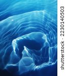 Closeup​ blur​ abstract​ of​ surface​ blue​ water. Abstract​ of​ surface​ blue​ water​ reflected​ with​ sunlight​ for​ background.Top​ view​ of blue​ water.​ Water​ splashed​ use​ for​ graphic​ design