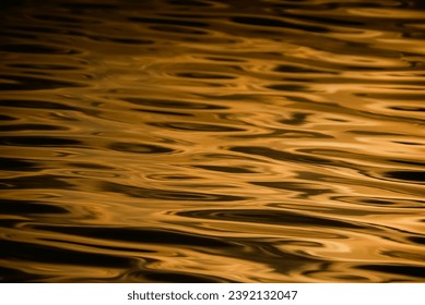 Closeup​ blur​ abstract​ of​ surface​ gold​ water. Abstract​ of​ surface​ gold​ water​ reflected​ with​ sunlight​ for​ background.Top​ view​ of blue​ water.​ Water​ splashed​ use​ for​ graphic​ design - Powered by Shutterstock