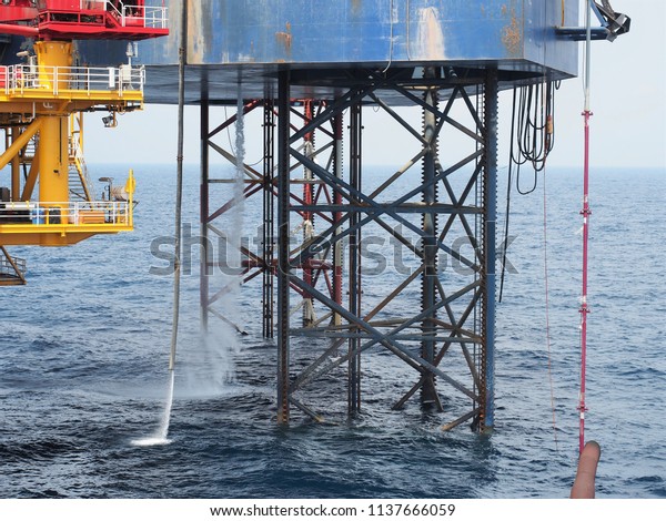Water\
is discharged from jack up rig\'s hull into the\
sea.