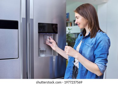 Water Dispenser, Woman Taking Cold Water Into Glass From Home Refrigerator