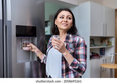 Water Dispenser, Woman Taking Cold Water Into Glass From Home Refrigerator