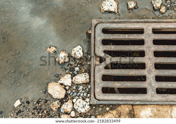 Water\
drains from the drain hatch. Drainage fountain of sewage. Accident\
in the sewage system. Dirty sewage flows on the road. Drainage\
system for wastewater discharge does not\
work
