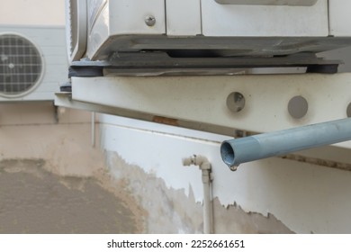 Water dripping from air conditioner. - Shutterstock ID 2252661651