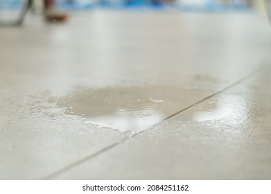 Water Drips Onto The Tiled Floor.