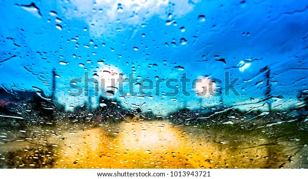 Water drop car concept. Droplet rain on mirror\
car is danger for transport. A small column of liquid is drop or\
droplet. It bounded completely by free surface. Liquid form drop\
exhibit surface tension