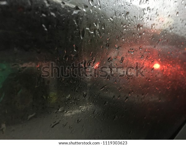 water drop at car windows. Drive car in rain on asphalt\
wet road. 