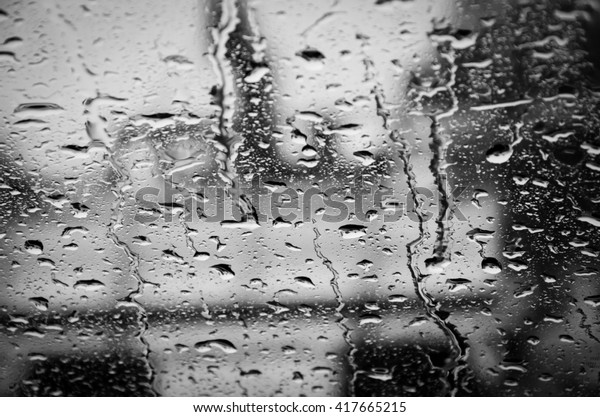 water\
drop down on the glass window in black and\
white