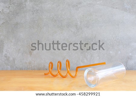 Water drop and Water glass on the wood table in front of the cement wall background 