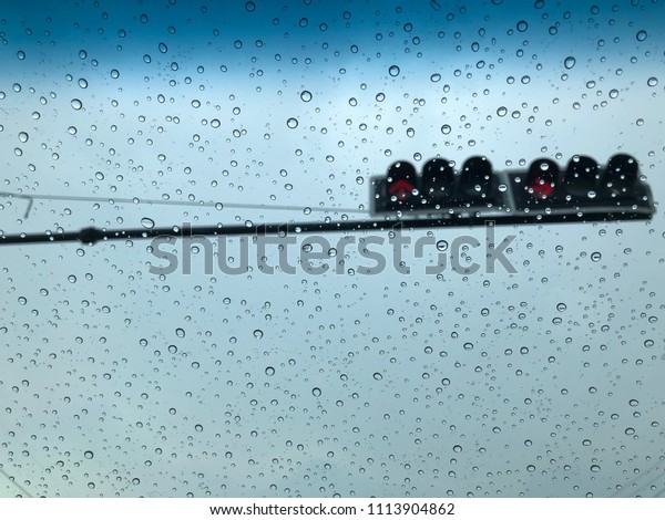 water drop\
on car glass, traffic blurred\
background