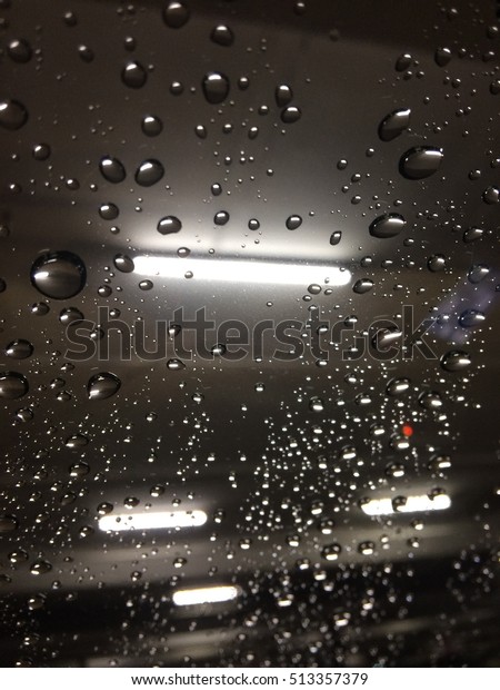 Water drop on a\
car mirror in the raining\
night