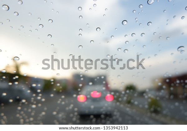water drop on car\
windshield . raining. 